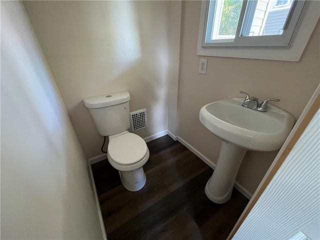 bathroom with wood-type flooring and toilet