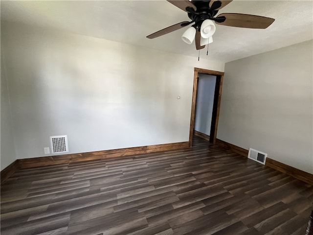 empty room with dark wood-type flooring and ceiling fan