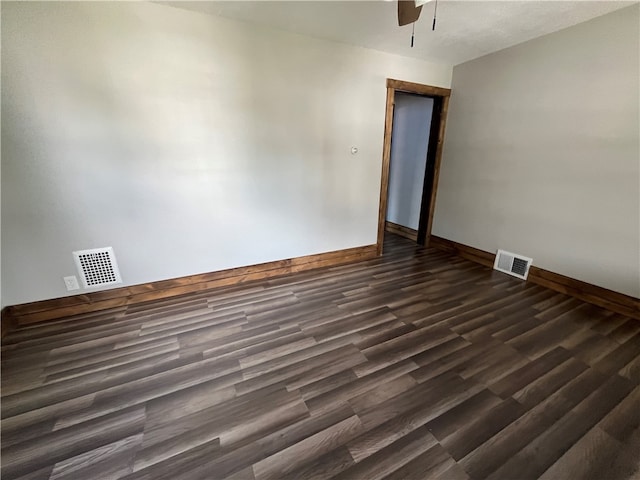 unfurnished room featuring dark wood-type flooring and ceiling fan