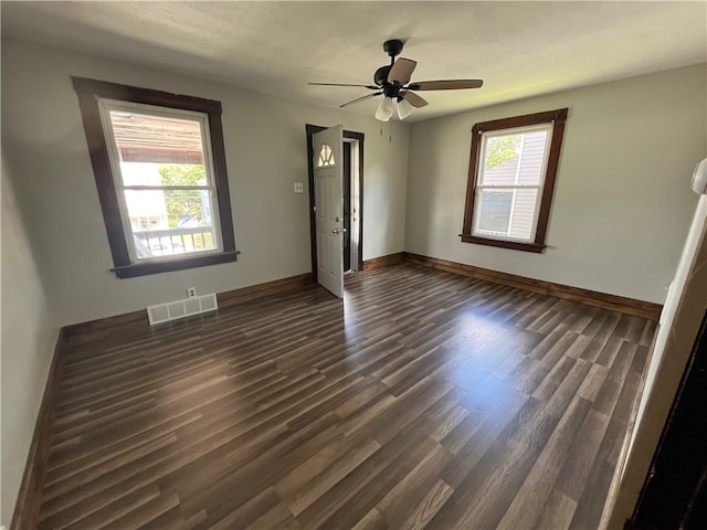 unfurnished room with ceiling fan and dark hardwood / wood-style flooring