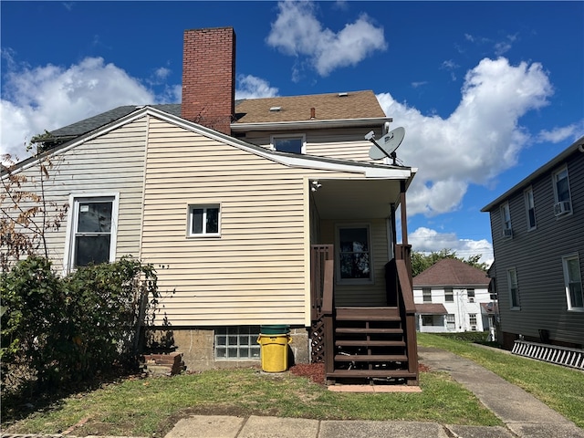 back of property featuring a yard