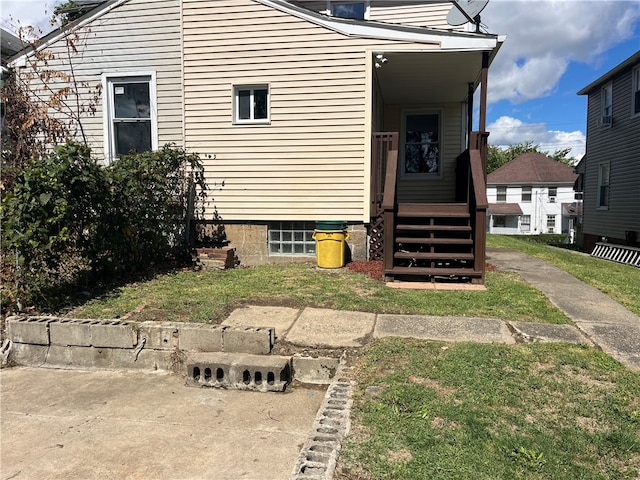 rear view of property featuring a lawn