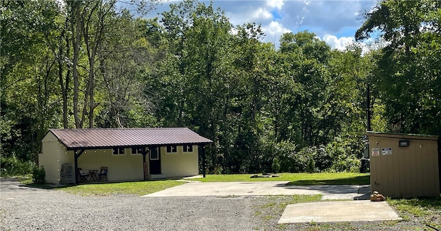 exterior space with covered porch and a front yard