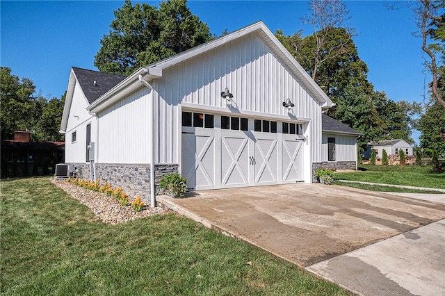 garage with a yard and cooling unit