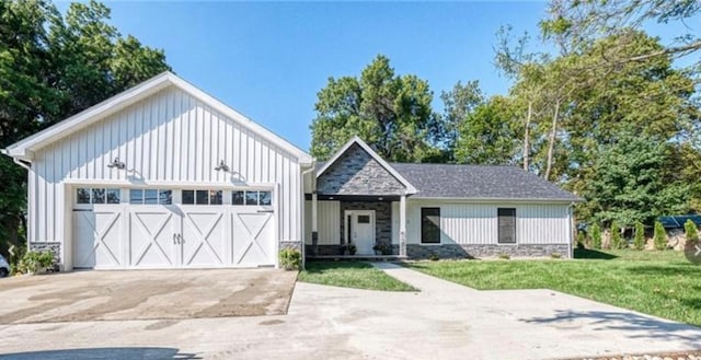 view of front of property with a garage and a front lawn