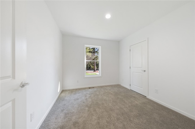 empty room featuring light colored carpet