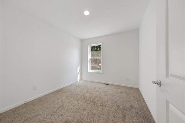 empty room with light colored carpet