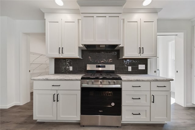 kitchen featuring white cabinets, decorative backsplash, stainless steel range with gas stovetop, and dark hardwood / wood-style floors