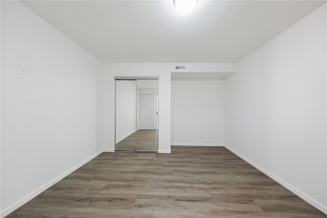 unfurnished bedroom with a closet and light hardwood / wood-style flooring