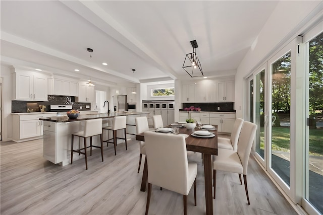 dining space with light hardwood / wood-style flooring