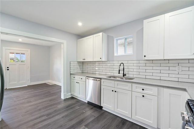 kitchen featuring tasteful backsplash, dark wood-type flooring, stainless steel appliances, sink, and white cabinetry