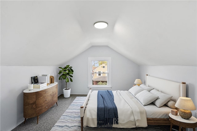 bedroom featuring lofted ceiling and carpet floors