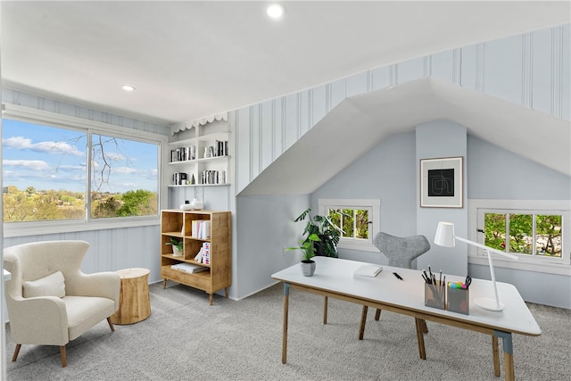 office featuring a wealth of natural light, vaulted ceiling, and light carpet