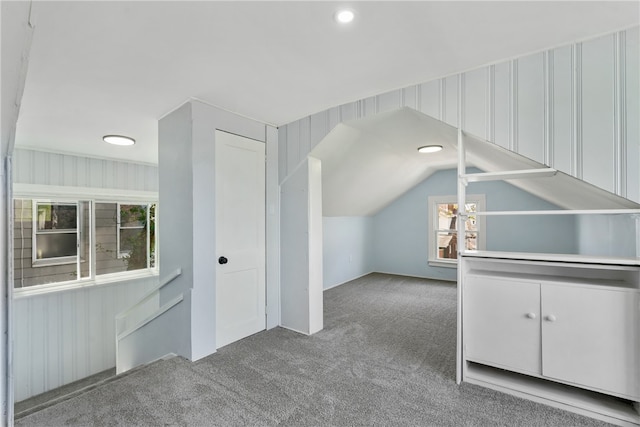 bonus room with lofted ceiling and carpet floors