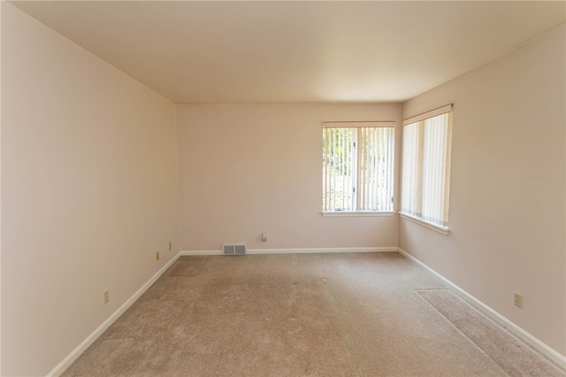 unfurnished room with light colored carpet