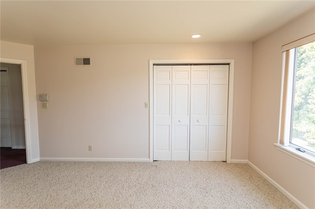 unfurnished bedroom with carpet and a closet