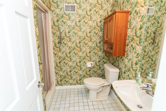 bathroom featuring tile patterned flooring, a shower with shower curtain, toilet, and sink