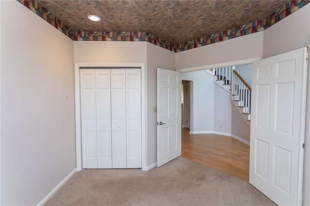 unfurnished bedroom with a closet and wood-type flooring