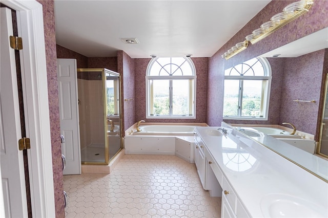 bathroom featuring tile patterned flooring, vanity, and plus walk in shower