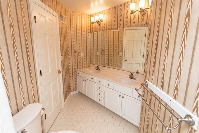 bathroom with vanity, toilet, and tile patterned flooring