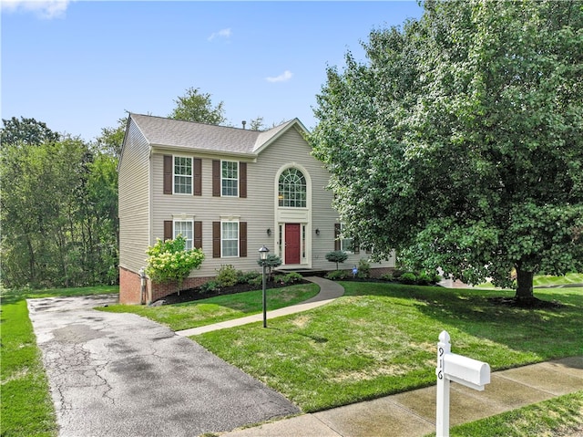 colonial inspired home with a front yard