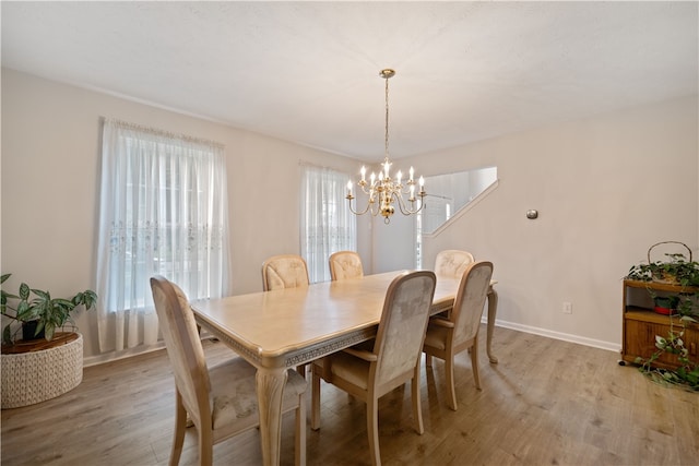 dining room featuring a chandelier and light hardwood / wood-style floors