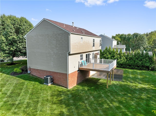 view of side of home with a lawn, a deck, and central AC