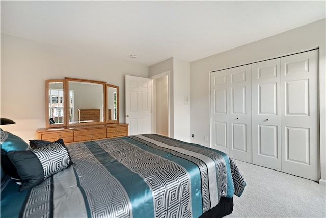 bedroom featuring a closet and light colored carpet