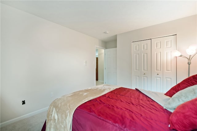 carpeted bedroom featuring a closet