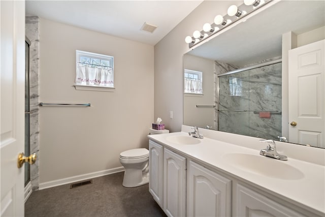 bathroom with vanity, toilet, a healthy amount of sunlight, and an enclosed shower