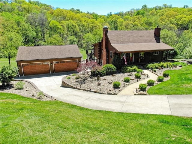 log-style house featuring a garage and a front lawn