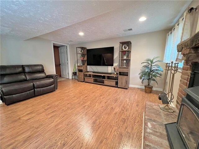 living room with a textured ceiling and hardwood / wood-style flooring