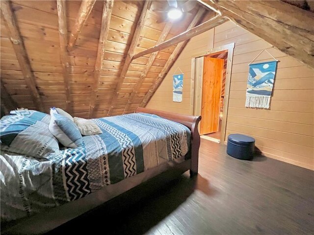 bedroom featuring vaulted ceiling, hardwood / wood-style floors, wooden walls, and wooden ceiling