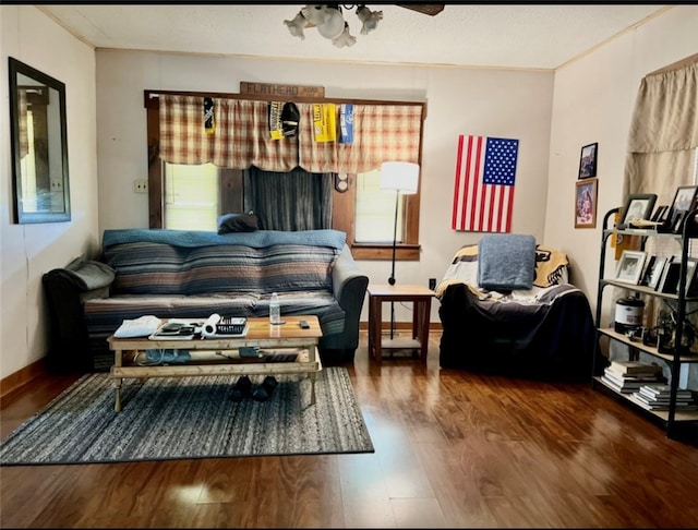 living room with ornamental molding, dark wood-type flooring, a healthy amount of sunlight, and ceiling fan