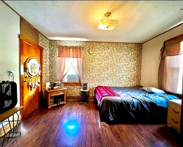 bedroom featuring crown molding, a textured ceiling, and dark hardwood / wood-style floors