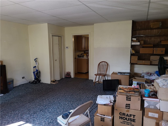 misc room featuring carpet flooring and wood walls