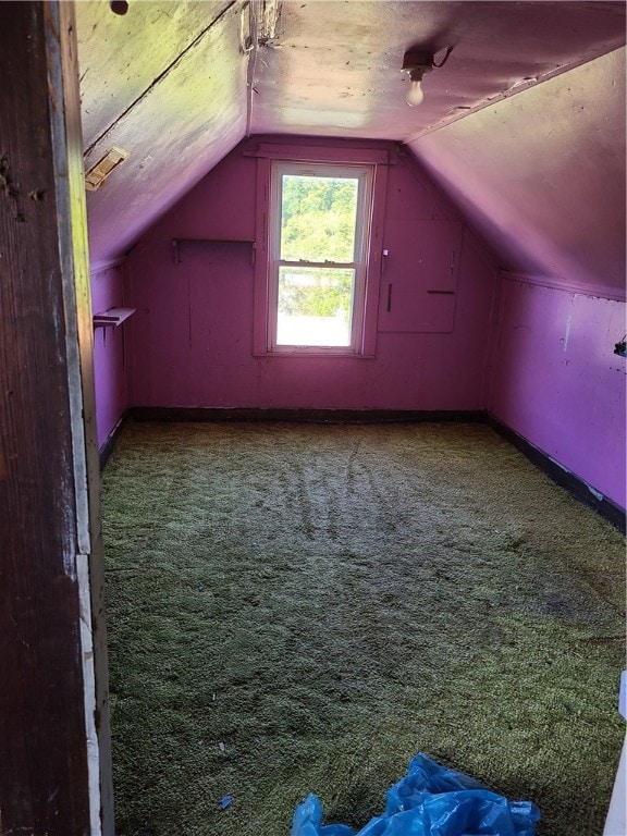 bonus room with lofted ceiling and carpet floors