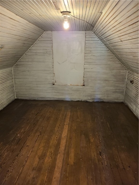 additional living space with lofted ceiling and dark hardwood / wood-style flooring