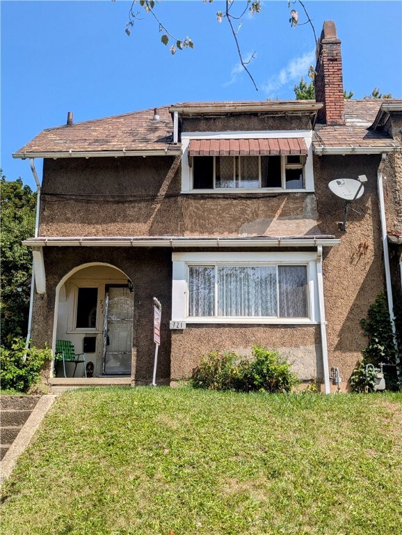 rear view of house with a yard