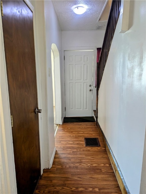 entryway featuring dark hardwood / wood-style floors and a textured ceiling