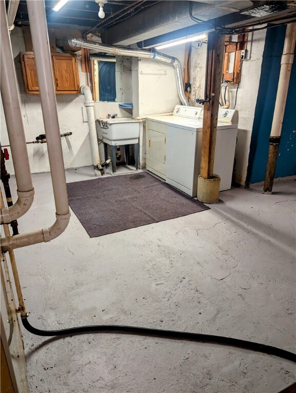 basement featuring washer and dryer and sink