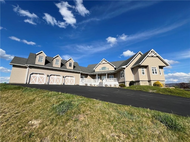 view of front of property featuring an attached garage and aphalt driveway