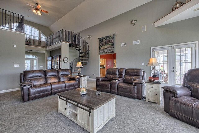 carpeted living room featuring high vaulted ceiling, ceiling fan, and french doors