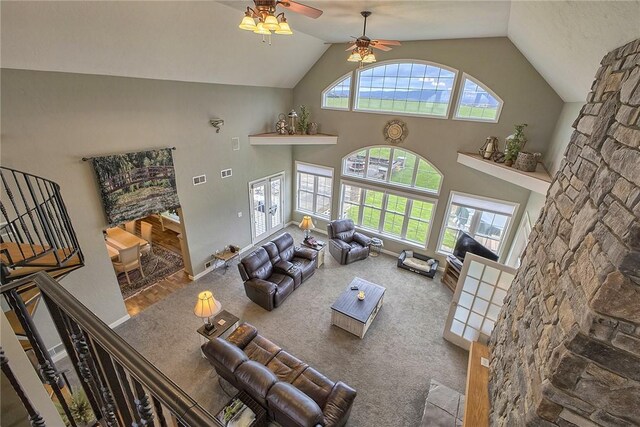 carpeted living room featuring a healthy amount of sunlight, ceiling fan, and high vaulted ceiling