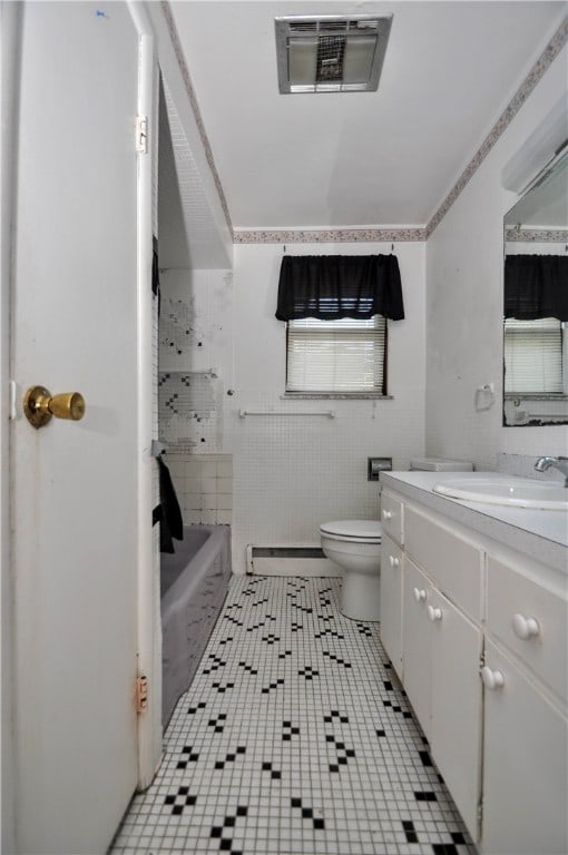 full bathroom featuring toilet, tile patterned floors, vanity, a baseboard radiator, and shower with separate bathtub