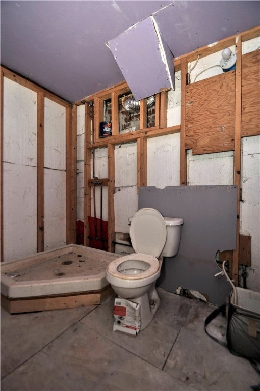 bathroom featuring walk in shower and toilet