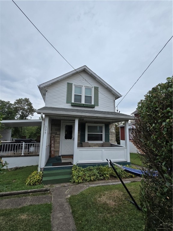 bungalow with a porch and a front yard