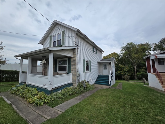 view of side of home with a yard