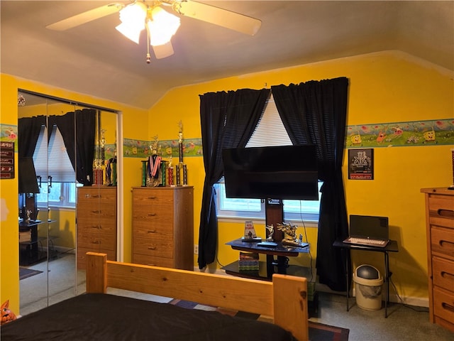 carpeted bedroom with lofted ceiling, a closet, and ceiling fan