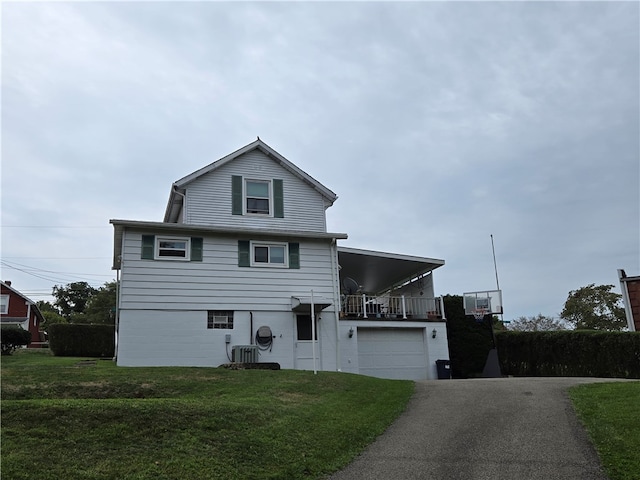 view of property with a garage, central AC unit, and a front lawn